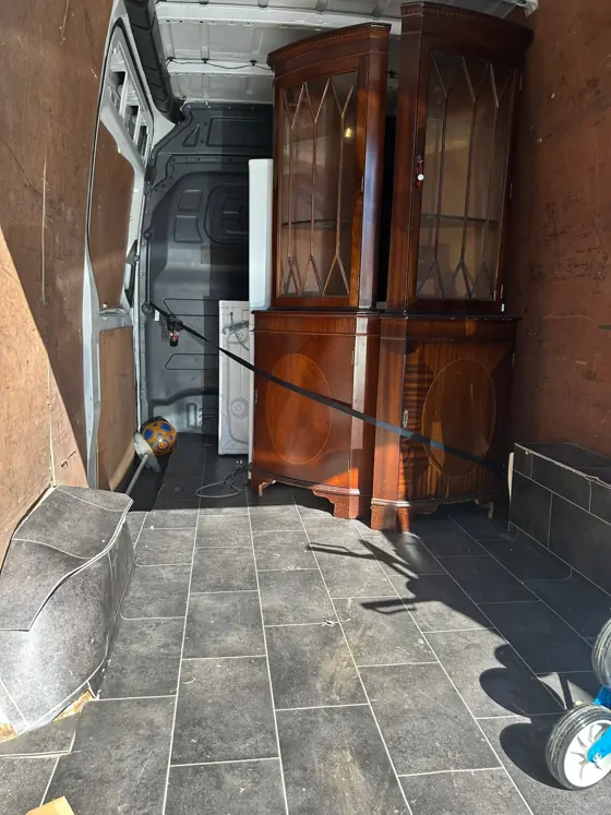 An antique cabinet, strapped to the wall for the journey.